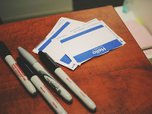 blank name tags with markers next to it