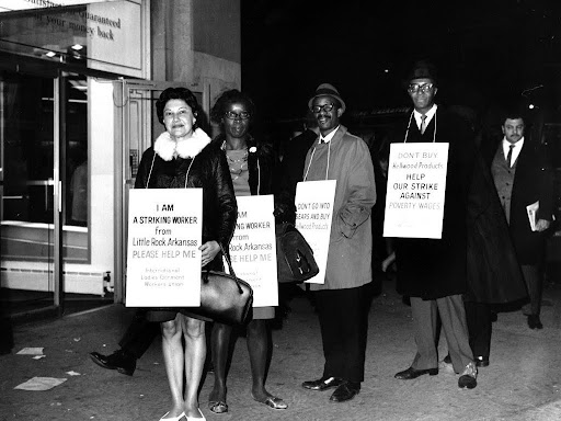 protestors wearing signs about a strike