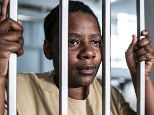 black woman grasping at bars