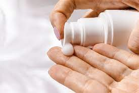 pumping sunscreen into open hand palm up