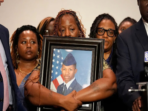 group of people holding photo of deceased airmen