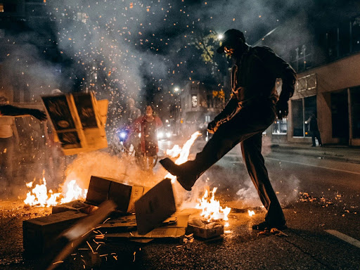 man in black t shirt and black pants holding fire