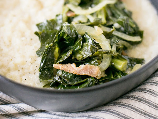 a bowl filled with rice and greens