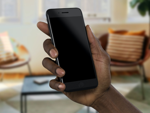 black person's hand holding a cell phone 