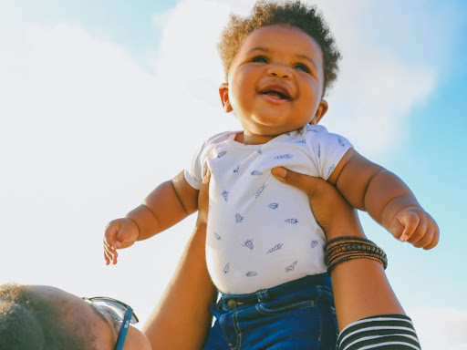 parent holding up a baby 