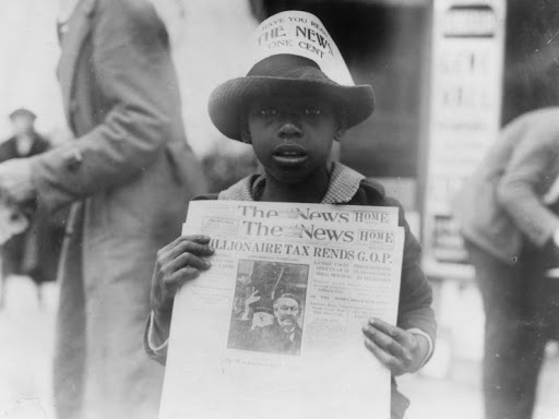 african american boy selling the washington daily news