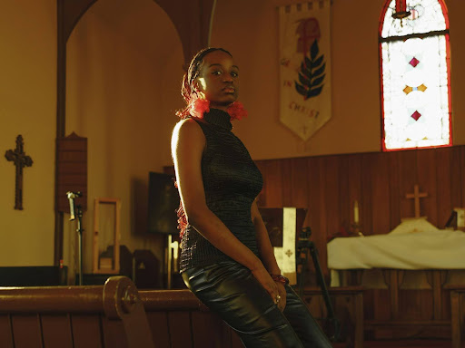 a woman sitting on a pew in a church