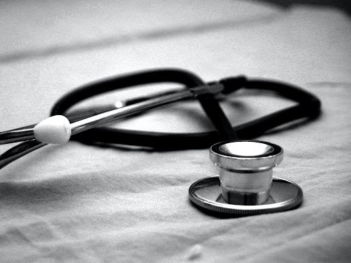 stethoscope laying on a metal table
