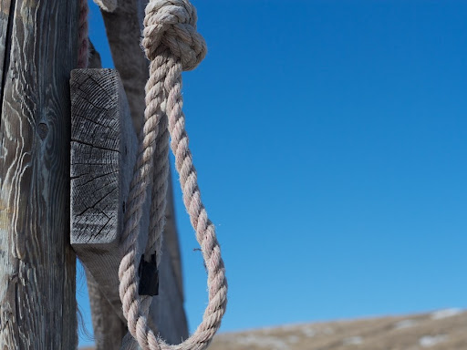 noose hanging off of a fence