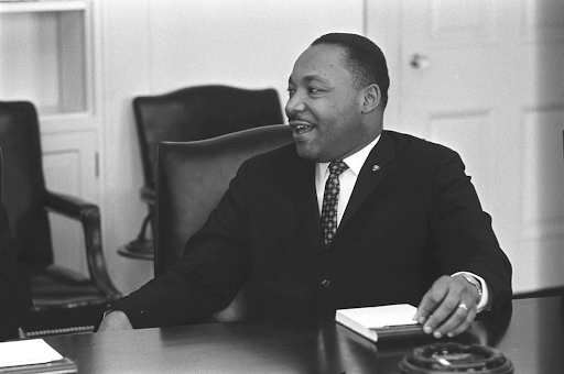 smiling mlk jr sitting down