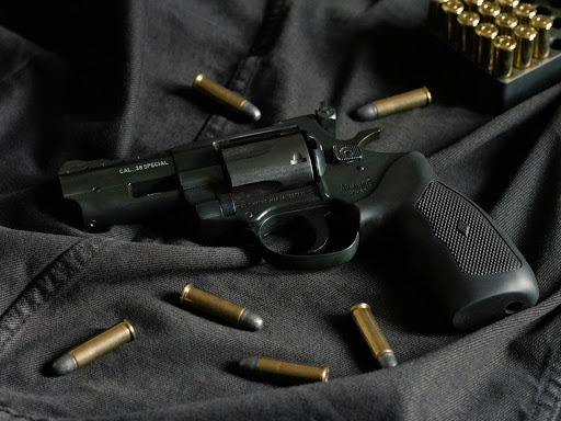 firearm with bullets around it 
