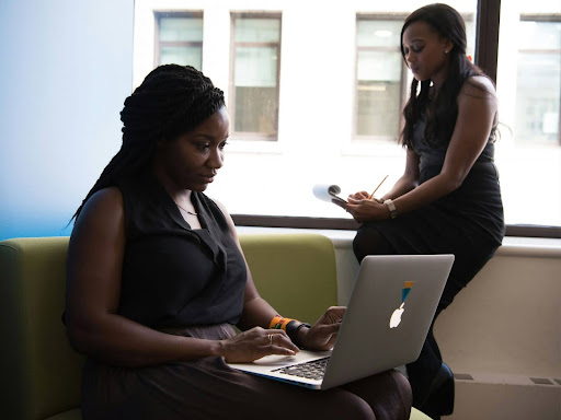 woman sitting down using a laptop