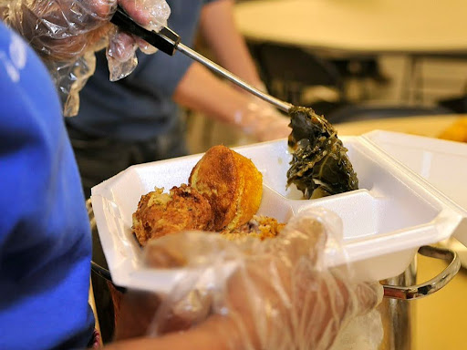 someone serving food on a tray