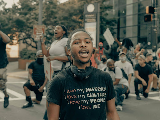 man in black crew neck t shirt standing on street during daytime 