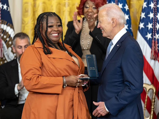 black woman receiving award from President biden