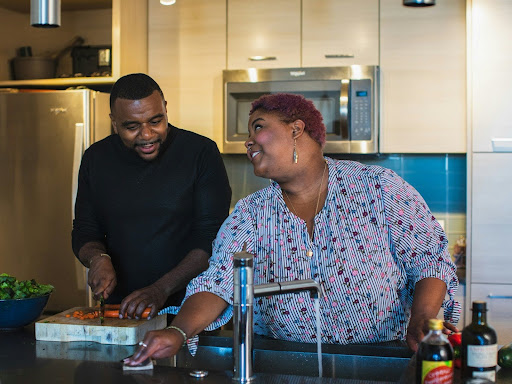 man and woman standing in front of sink