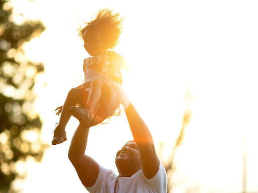 parenting raising their child into the air