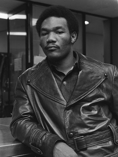 younger george foreman in a jacket