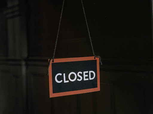 white and black stop sign that says closed
