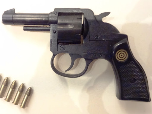 gun with bullets next to it 