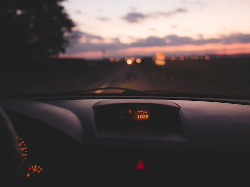 car dashboard with the outside being a sunset