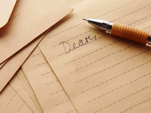 pen on top of letter writing paper 