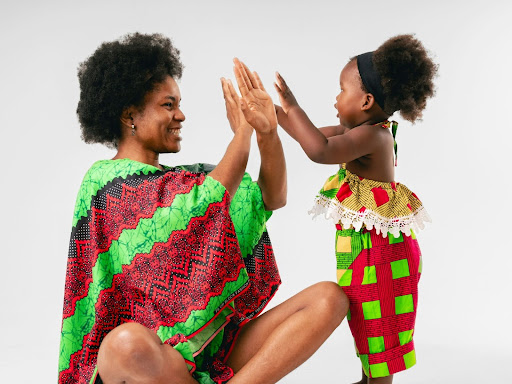 mother and daughter give each other a high five
