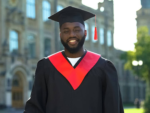 happy black student in a graduation gown