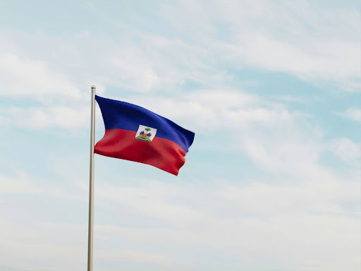 flag flying in the wind with a blue sky in the background 