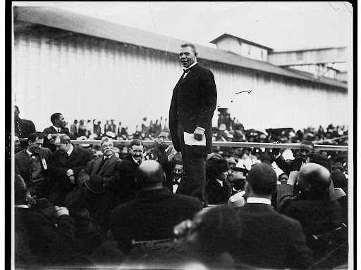 booker t washington standing on a stage
