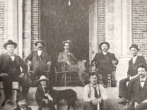 people seated in chairs in the doorway