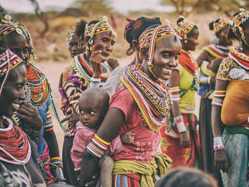 group of people standing on brown ground
