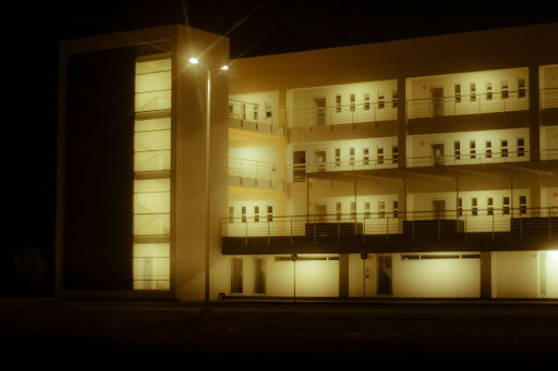 a building lit up at night with lights on