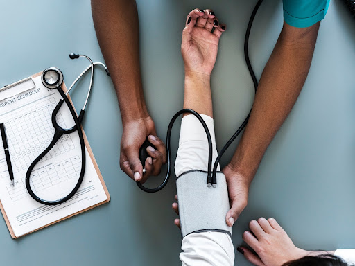 doctor taking blood pressure of a patient