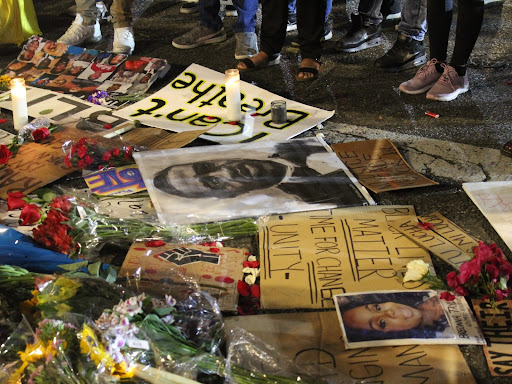 photos and candles in a pile for a memorial