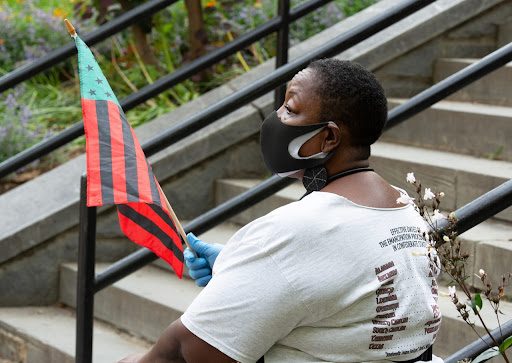 woman holding african american flag