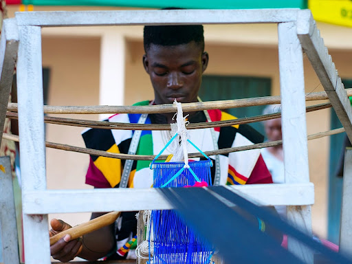 frontal view of a kente weaver