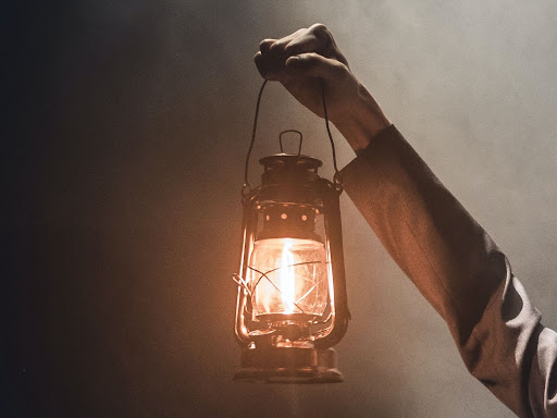 person holding a lantern