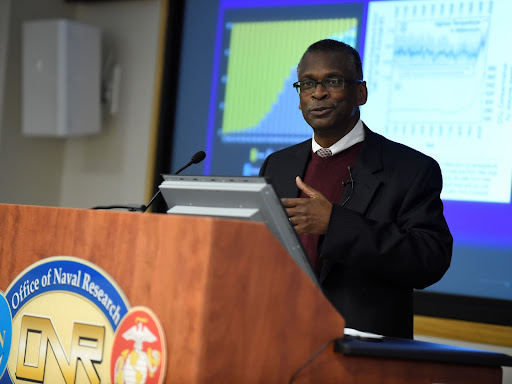 lonnie johnson speaking at a podium