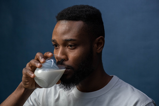 man drinking a glass of milk