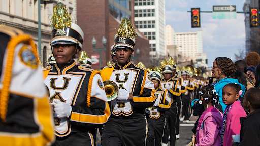 marching band marching down a street 