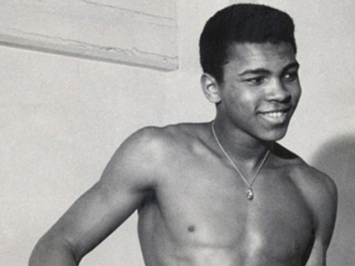 young muhammad ali smiling shirtless 