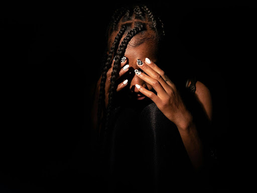a woman covering her face with her hands 