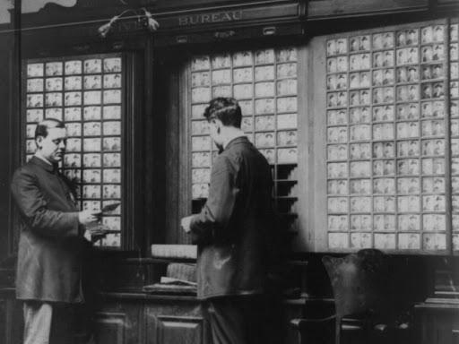 two men standing in front of mugshot gallery