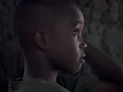 little black boy with a sullen look 