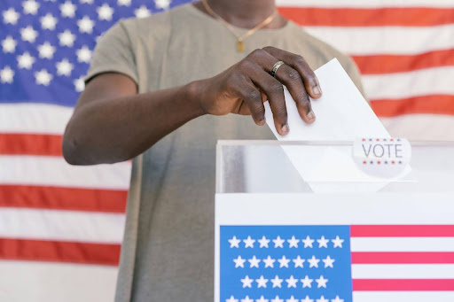 person putting his vote in a ballot box