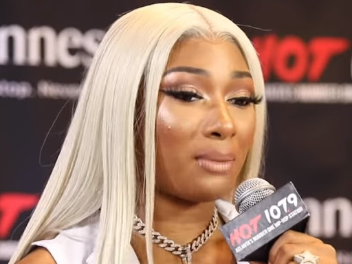 megan thee stallion holding up a microphone