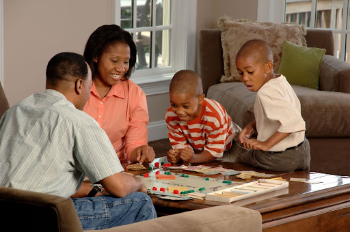 family playing a board game together 