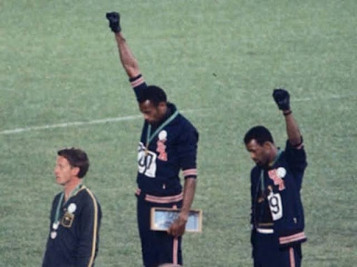 raising fists at olympics