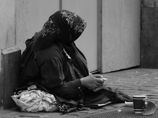 person sitting down with their head and body covered 